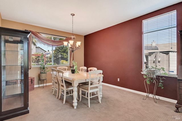 dining space featuring a wealth of natural light, baseboards, and a notable chandelier