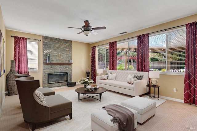 carpeted living room featuring visible vents, ceiling fan, and a healthy amount of sunlight