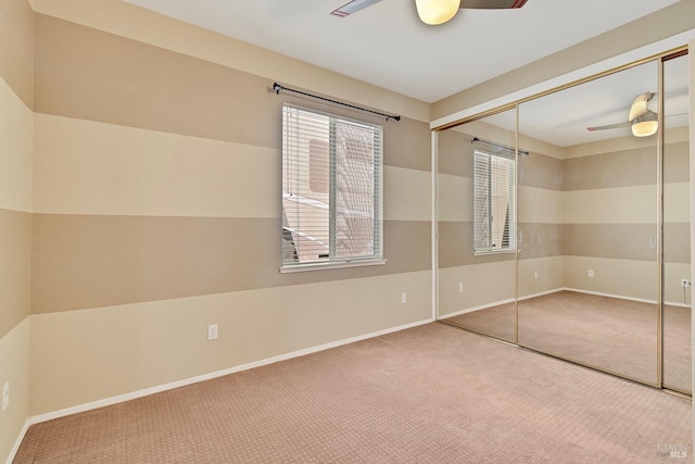 unfurnished bedroom with baseboards, carpet, and a closet