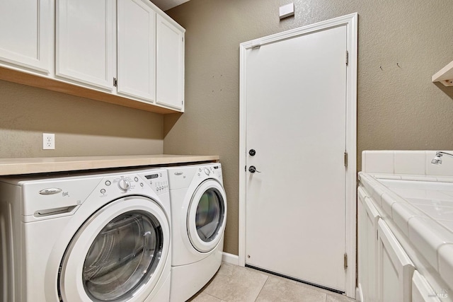 laundry room with washer and dryer, cabinet space, a sink, and light tile patterned floors