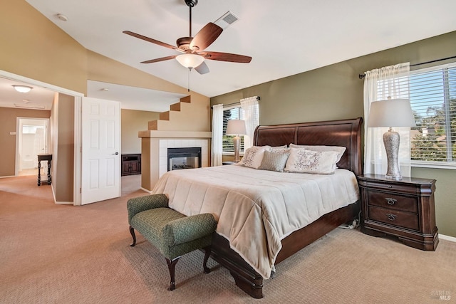 carpeted bedroom with lofted ceiling, baseboards, visible vents, and multiple windows