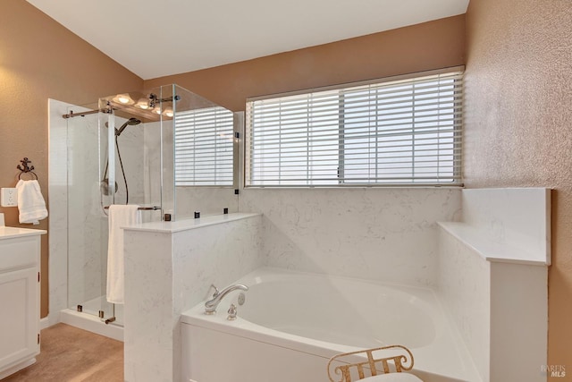 bathroom with a bath, plenty of natural light, and a marble finish shower