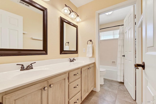 full bath with double vanity, visible vents, toilet, and a sink