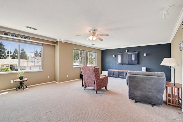 living area with ceiling fan, visible vents, ornamental molding, and light colored carpet