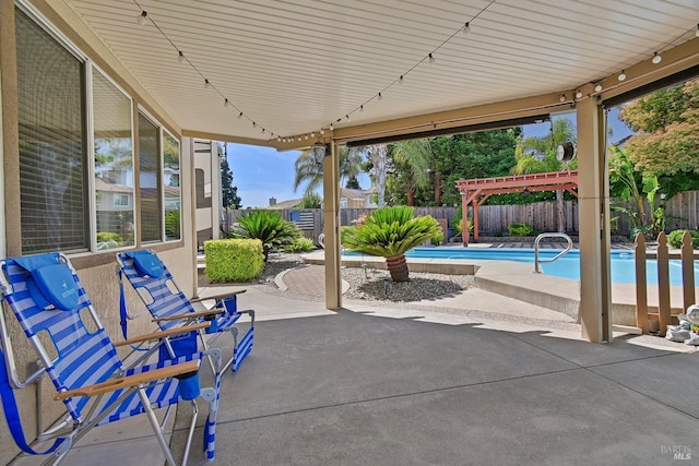 view of patio featuring a pergola, a fenced backyard, and a fenced in pool