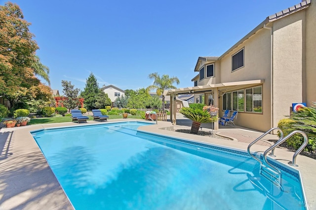 pool featuring a pergola and a patio area