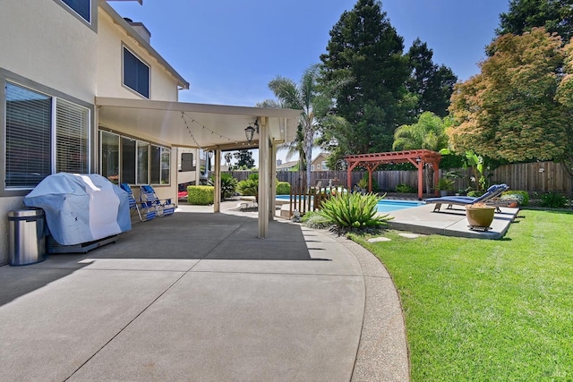 view of patio / terrace with grilling area, a fenced backyard, a fenced in pool, and a pergola