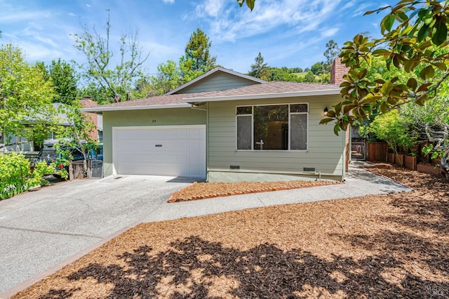 single story home featuring crawl space, a chimney, driveway, a shingled roof, and an attached garage