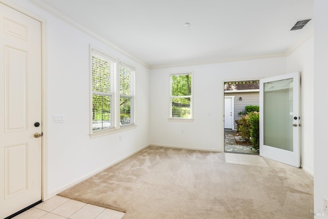 unfurnished room featuring baseboards, ornamental molding, visible vents, and carpet