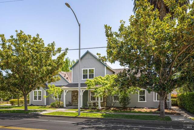 view of front of home featuring roof with shingles