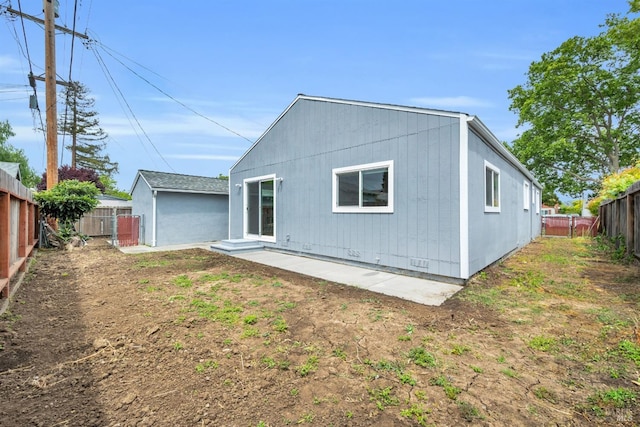 rear view of house with a patio and a fenced backyard