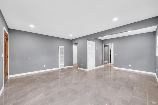 empty room with baseboards and recessed lighting