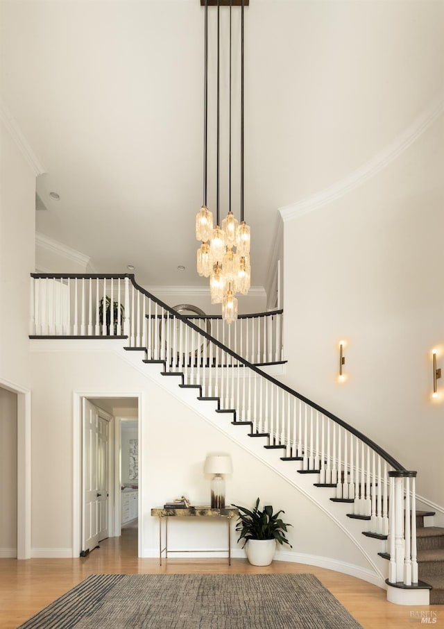 656 Goodhill Rd, Kentfield, CA 94904 - stairway featuring a chandelier, wood finished floors, a towering ceiling, and ornamental molding