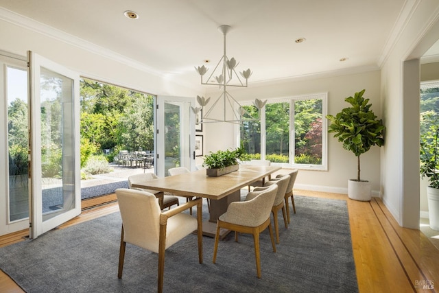 656 Goodhill Rd, Kentfield, CA 94904 - dining area with light wood-style flooring, a healthy amount of sunlight, ornamental molding, and an inviting chandelier