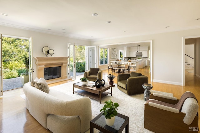 656 Goodhill Rd, Kentfield, CA 94904 - living room with crown molding, baseboards, a glass covered fireplace, light wood-style flooring, and stairs