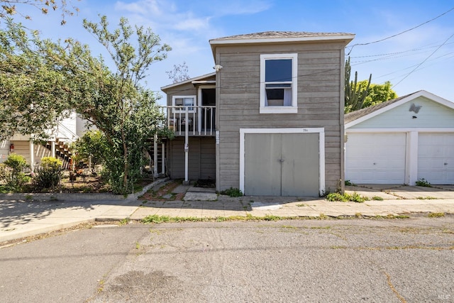 traditional-style house featuring an outdoor structure and a detached garage