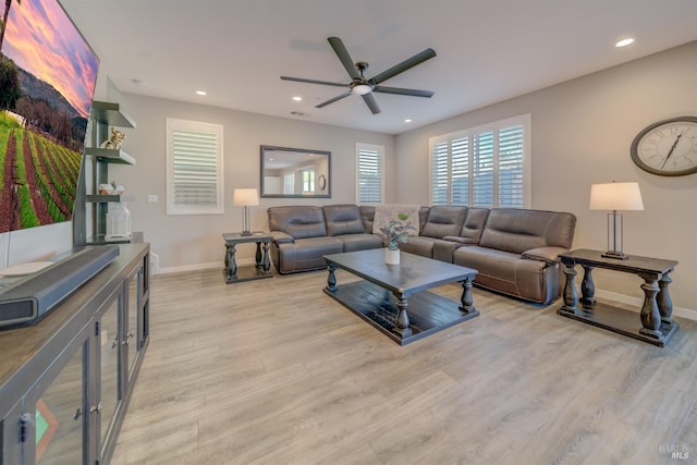 living area with recessed lighting, baseboards, ceiling fan, and light wood-type flooring
