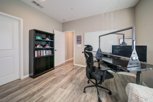 office featuring baseboards, wood finished floors, and visible vents