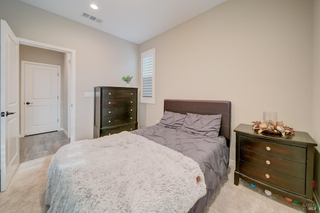 carpeted bedroom with baseboards, vaulted ceiling, and visible vents