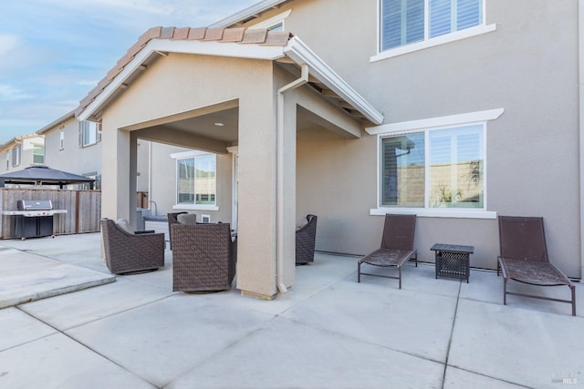 view of patio featuring fence, grilling area, and outdoor lounge area