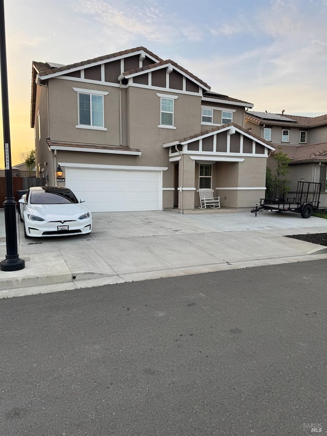 view of front of house with stucco siding, driveway, and a garage