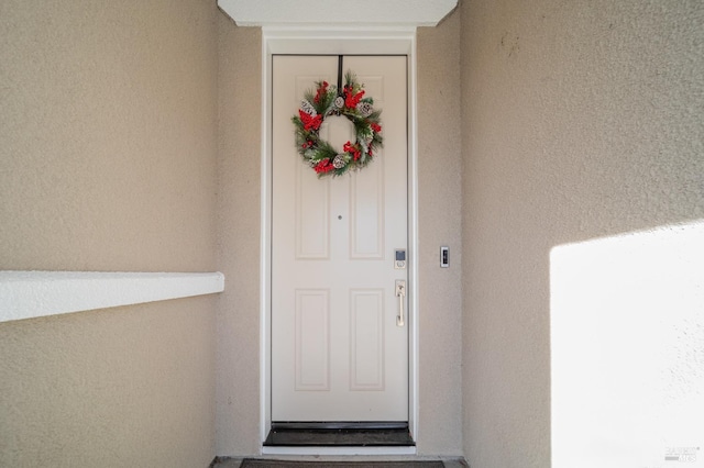property entrance featuring stucco siding