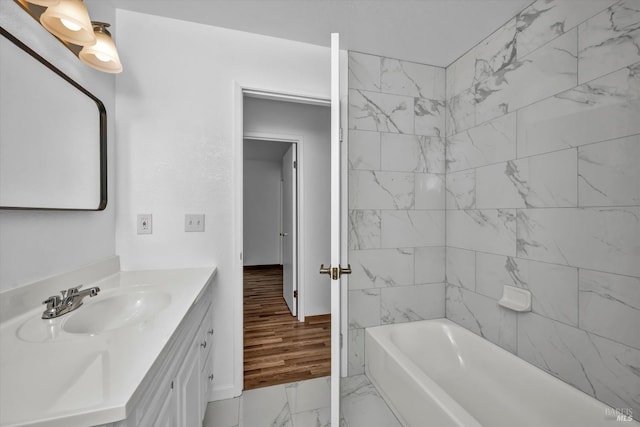 full bathroom featuring marble finish floor, shower / bath combination, and vanity