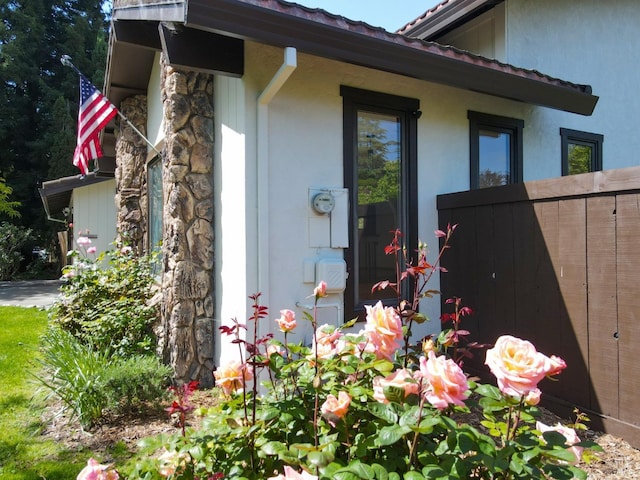 view of side of property with stone siding and stucco siding