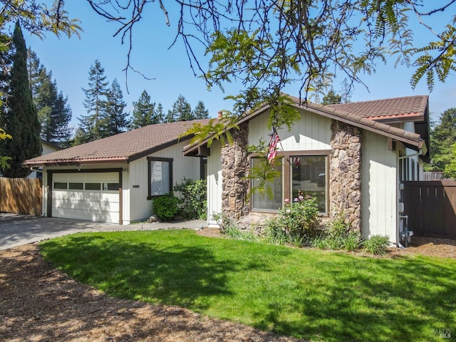 ranch-style home with a front lawn, stone siding, an attached garage, and fence