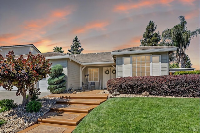 split level home with a lawn and a garage