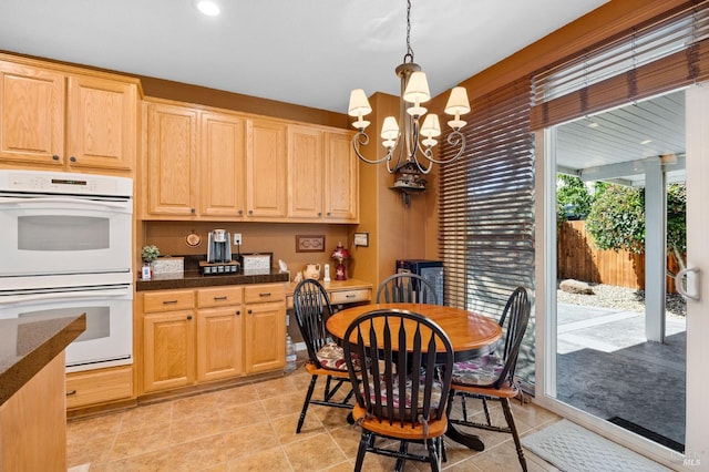 dining area featuring light tile patterned floors, recessed lighting, and a chandelier