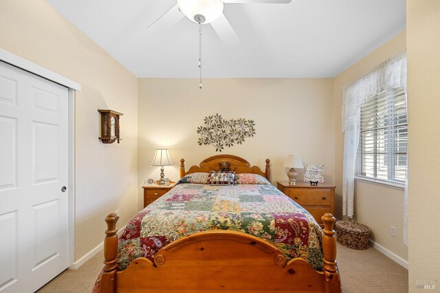 carpeted bedroom with baseboards and a ceiling fan