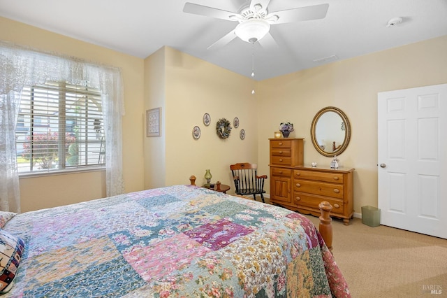 bedroom with carpet floors, ceiling fan, and visible vents