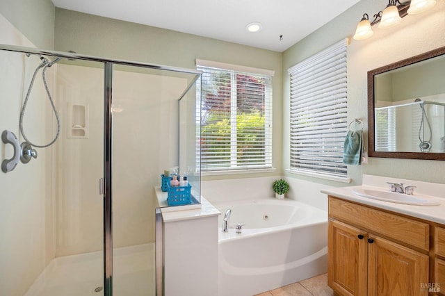 full bathroom featuring vanity, a stall shower, tile patterned floors, and a garden tub