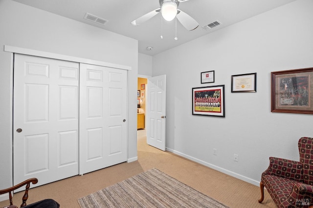 sitting room featuring visible vents, baseboards, ceiling fan, and light carpet
