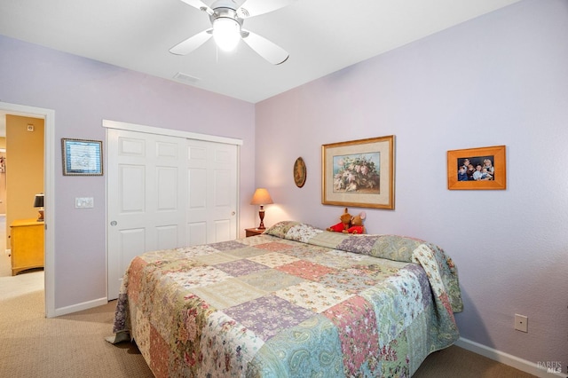bedroom featuring baseboards, light colored carpet, visible vents, and a closet