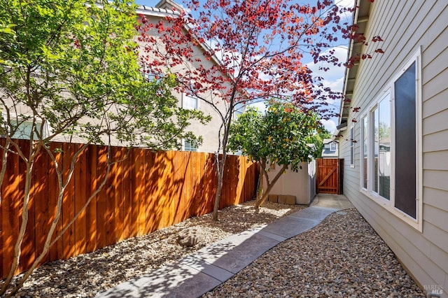 view of yard with fence and a gate