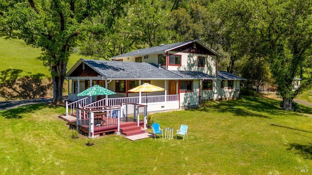 back of property featuring a lawn and a view of trees