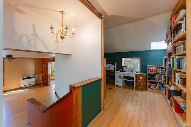 28900 Timberline Rd, Willits, CA 95490 - office space featuring light wood-style flooring, high vaulted ceiling, heating unit, and ceiling fan with notable chandelier