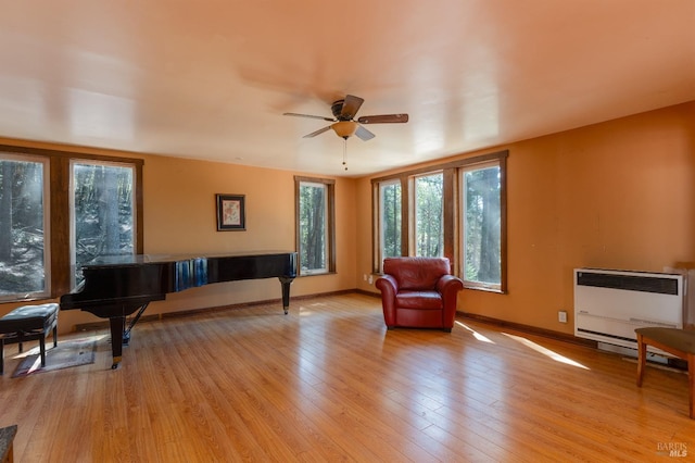 28900 Timberline Rd, Willits, CA 95490 - living area featuring light wood-type flooring, a ceiling fan, baseboards, and heating unit
