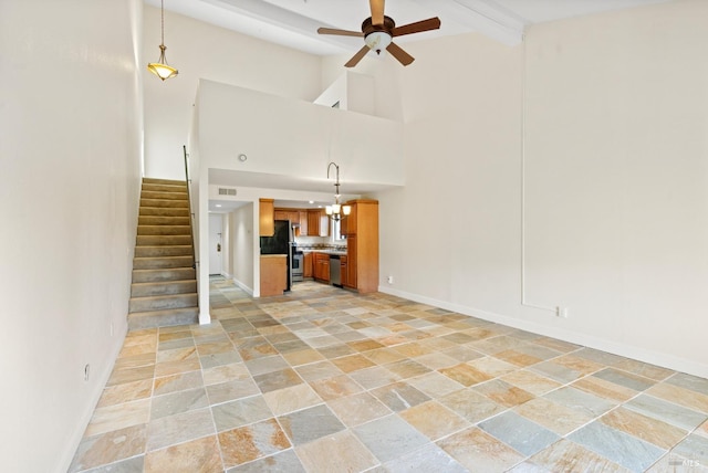 unfurnished living room with ceiling fan, visible vents, high vaulted ceiling, stone tile flooring, and stairs