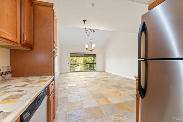 kitchen featuring brown cabinetry, light countertops, tasteful backsplash, appliances with stainless steel finishes, and a notable chandelier
