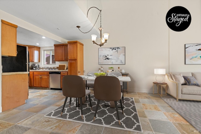 dining room with stone tile flooring, recessed lighting, baseboards, and a notable chandelier