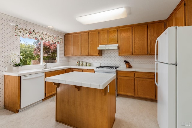 116 Philip Dr, Healdsburg, CA 95448 - kitchen featuring brown cabinetry, a kitchen island, a sink, under cabinet range hood, and white appliances