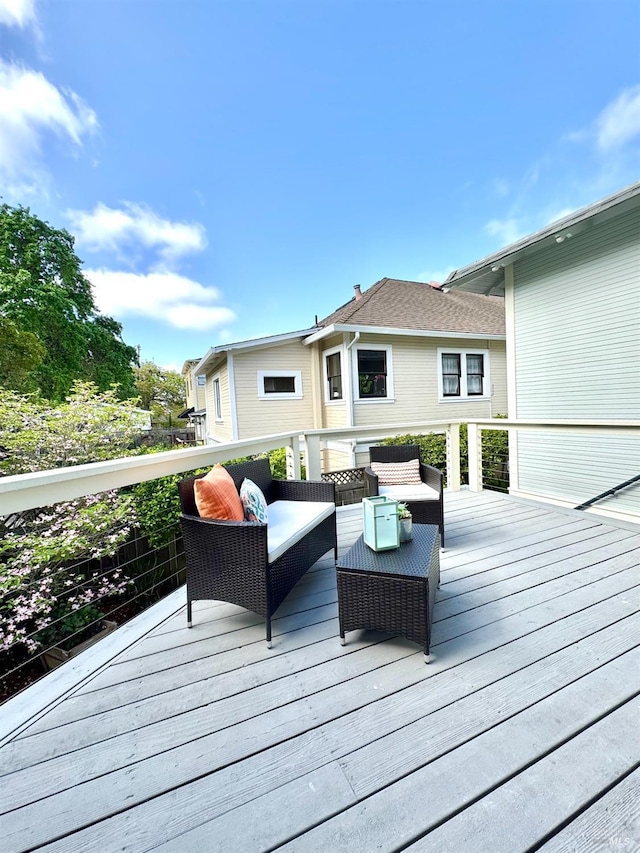wooden terrace featuring an outdoor living space
