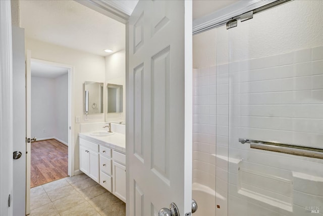 full bathroom featuring vanity, tile patterned flooring, and a shower with door