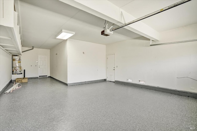 garage with secured water heater, a garage door opener, and baseboards
