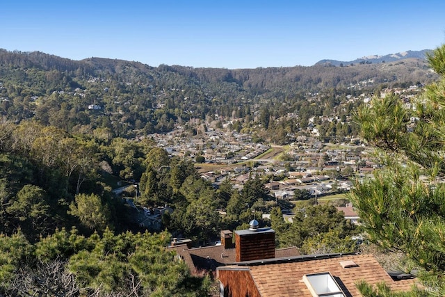 drone / aerial view featuring a view of trees and a mountain view
