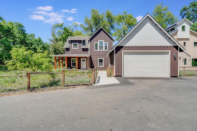2701 Swanston Oaks, Sacramento, CA 95818 - view of front of home with board and batten siding, a garage, and driveway