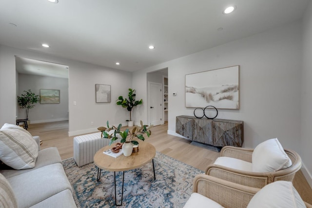 living room with recessed lighting, light wood finished floors, and baseboards